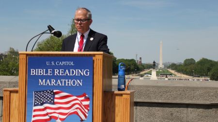 Abe Silos of Gideons International reads from the Bible outside of the U.S. Capitol as part of the annual Bible Reading Marathon on April 29, 2025.