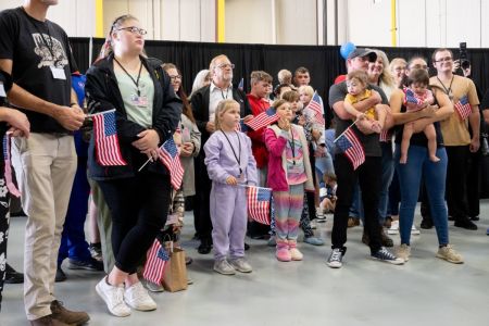 The first group of Afrikaners from South Africa to arrive for resettlement listen to remarks from U.S. Deputy Secretary of State Christopher Landau and U.S. Deputy Secretary of Homeland Security Troy Edgar after they arrived at Washington Dulles International Airport in Dulles, Virginia, on May 12, 2025. 