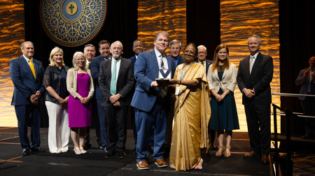 Ananthi Jebasingh (right), founder and director of the Good Samaritan School in New Delhi, India, receives the William Wilberforce Award from Colson Center President John Stonestreet (left) and members of the board at the Colson Center National Conference in Louisville, Kentucky, on May 31, 2025. 