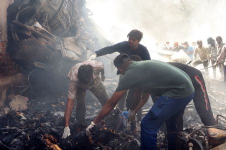 Rescue officials work at the site where Air India flight 171 crashed in a residential area near the airport in Ahmedabad on June 12, 2025. The London-bound passenger plane crashed on June 12 in India's western city of Ahmedabad with 242 on board, aviation officials said in what the airline called a