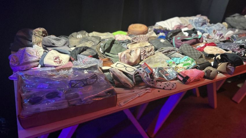 A table of the victims' belongings on display at the Nova Music Festival exhibition in Washington, D.C.