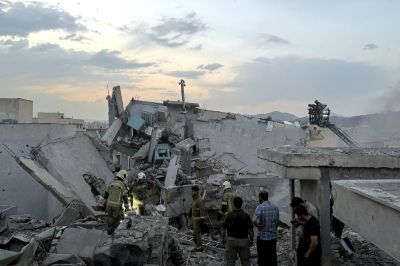 People and first-responders gather atop a building that was hit by an Israeli strike in Tehran on June 13, 2025. Israel hit about 100 targets in Iran on June 13, including nuclear facilities and military command centres and killing senior figures including the armed forces chief and top nuclear scientists. 