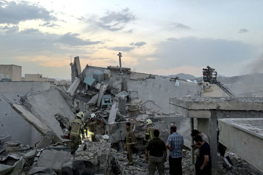 People and first-responders gather atop a building that was hit by an Israeli strike in Tehran on June 13, 2025. Israel hit about 100 targets in Iran on June 13, including nuclear facilities and military command centers and killing senior figures including the armed forces chief and top nuclear scientists. 