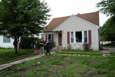 Vance Boelter's roommate, who declined to give his name, speaks with a Minneapolis police officer outside his home on June 14, 2025 in Minneapolis, Minnesota. Boelter a suspect in the shooting of two Democratic-Farmer-Labor lawmakers. DFL State Rep. Melissa Hortman and her husband, Mark Hortman, were shot and killed this morning. DFL State Sen. John Hoffman and his wife were also shot and hospitalized in a separate incident. Minnesota Gov. Tim Walz said during a press conference that the shooting 