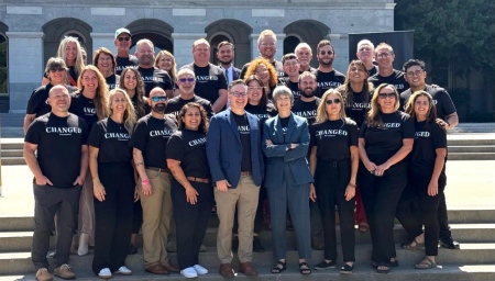 Participants of the CHANGED Movement's event gather in front of the California state Capitol in Sacramento on June 12, 2025. CHANGED co-founder Ken Williams stands in the front row, fifth from left.