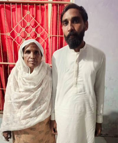 Farhan Javed Masih stands beside his mother after his release from prison on June 12, 2025. 