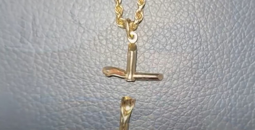 A cross necklace credited with saving Aidan Perry, 20, from a potentially fatal gunshot wound remains intact although the cross itself is broken. 