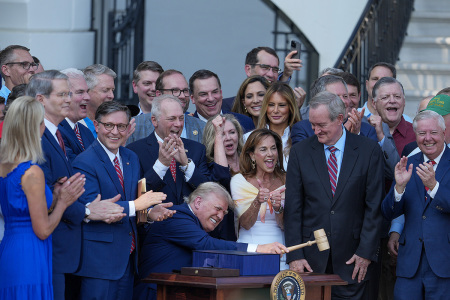 President Donald Trump, joined by Republican lawmakers, signs the One, Big Beautiful Bill Act into law during an Independence Day military family picnic on the South Lawn of the White House on July 04, 2025, in Washington, DC. After weeks of negotiations with Republican holdouts Congress passed the "One, Big Beautiful Bill" Act into law, President Trump’s signature tax and spending bill. The bill makes permanent President Donald Trump’s 2017 tax cuts, increase spending on defense and illegal immigration enforcement and temporarily cut taxes on tips and overtime. 