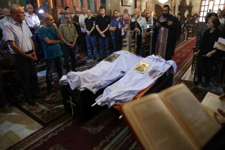 Archbishop Alexios blesses the bodies of Saad Salameh and Foumia Ayyad, killed earlier in an Israeli strike that hit the Holy Family church in Gaza City, during their funeral ceremony at the Saint Porphyrius Church on July 17, 2025. An Israeli strike on Gaza's only Catholic church killed three people on July 17, the Latin Patriarchate of Jerusalem said, as Israel said it 