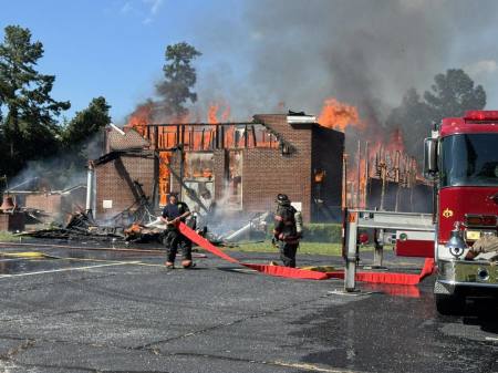 Firefighters work to put out a massive fire at Pleasant Grove Baptist Church in Darlington County, South Carolina, on July 19, 2025.