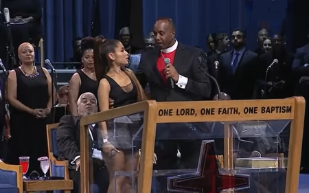 Pastor Charles Ellis of the Greater Grace Temple in Detroit, Michigan, speaks with his hand near singer Ariana Grande's chest after she performed at the funeral service for Aretha Franklin on Aug. 31, 2018.