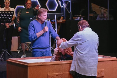 Pastor Charles Muller (with microphone) leads Victory Church in Albany, New York. 
