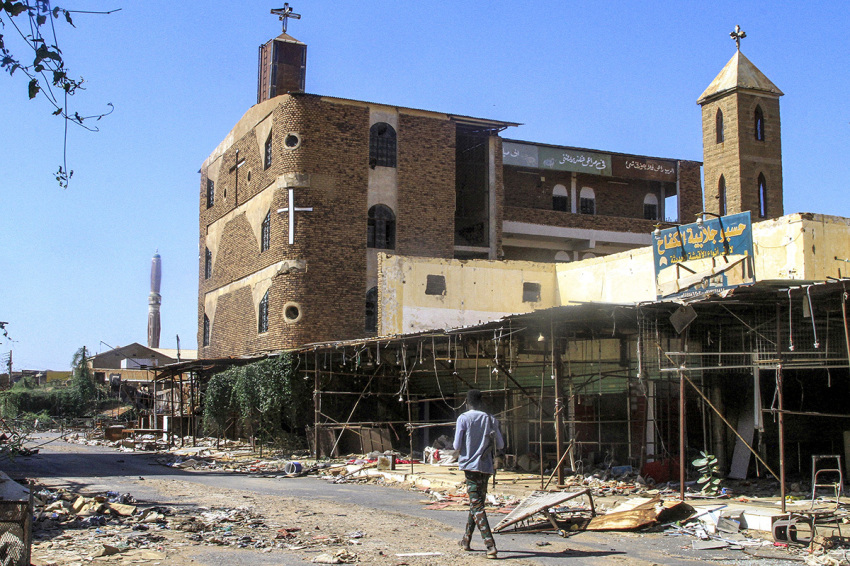 A man walks outside the damaged building and annex of the Evangelical Presbyterian Church Khartoum North, in Khartoum North on March 17, 2025. 