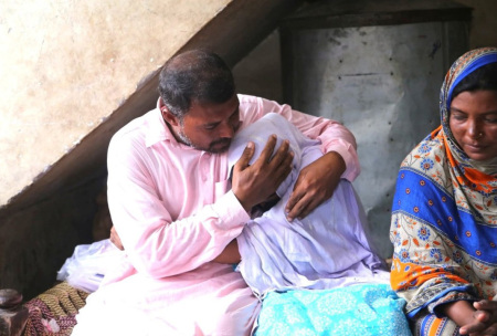 Javed Masih comforts his daughter as he and his wife speak with legal aid group Christians’ True Spirit.