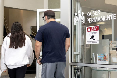 People walk past the entrance of Kaiser Permanente Medical Office in Manhattan Beach, California, on July 19, 2024. 