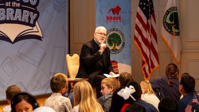 Rev. Paul Hartmann of the United States Conference of Catholic Bishops reads to children at the Library of Congress for Brave Books’ third annual See You At The Library celebration on Aug. 16, 2025. 