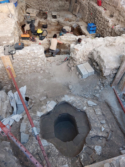 An exterior baptistery is seen in front of archaeologists working on unearthed remains of an early Christian cathedral in Vence, southeastern France, on July 31, 2025. 
