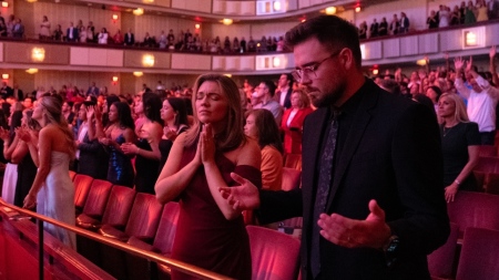 Attendees pray during the premiere of "The Revival Generation" at The John F. Kennedy Center for the Performing Arts in Washington, D.C., on Aug. 27, 2025.