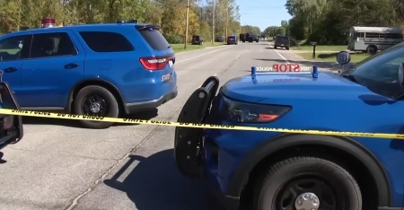 Police cars sit down street where emergency services are responding to a shooting and fire at the Church of Jesus Christ of Latter-day Saints on Sept. 28, 2025, in Grand Blanc, Michigan.