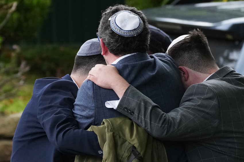 Members of the public react as they gather near the Heaton Park Hebrew Congregation Synagogue, where multiple were injured after stabbing and car attack on Yom Kippur, on Oct. 2, 2025, in the Crumpsall suburb of Manchester, England. Greater Manchester Police said they were called to the scene shortly after 9:30 a.m., when a witness said the assailant drove a car at people and then stabbed someone. Police then shot the suspected attacker. 