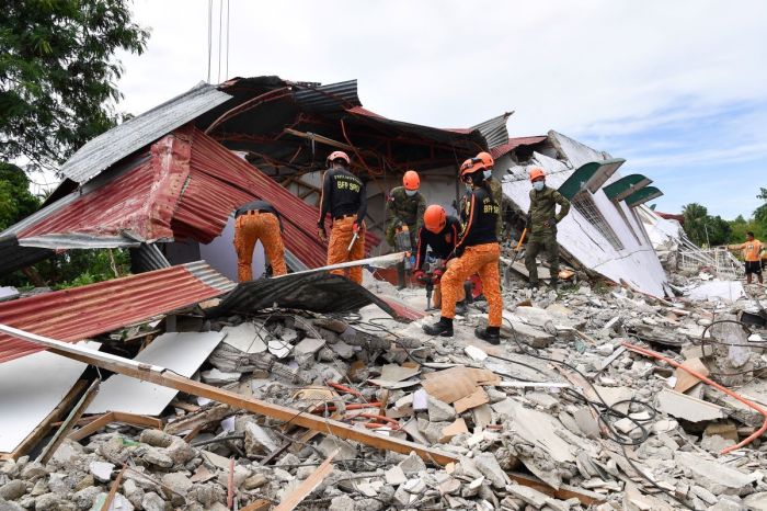 Rescuers search for three people who were reported missing under the rubble of a collapsed building in Bogo City on October 1, 2025, after a powerful 6.9 magnitude earthquake jolted the central Philippines, killing dozens on the island of Cebu with fears the toll could rise.