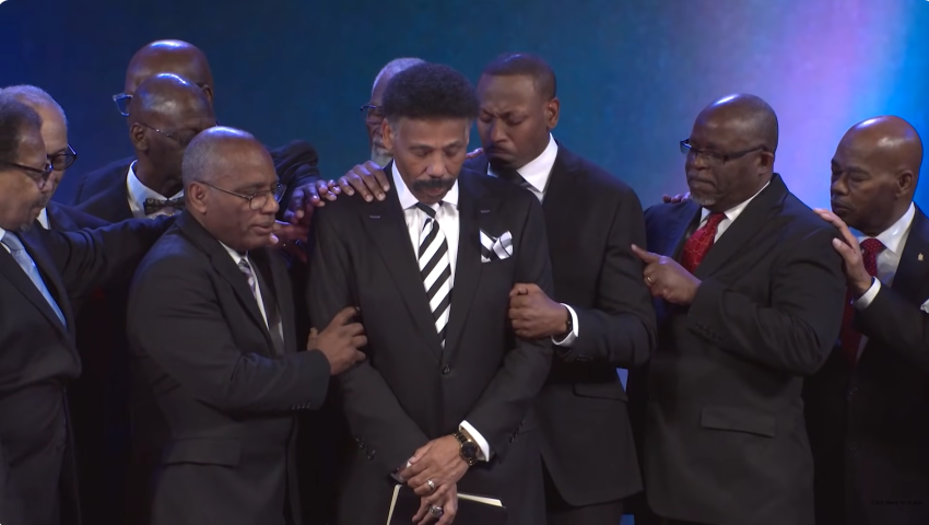 Elders of Oak Cliff Bible Fellowship Church in Dallas, Texas, pray over founder Tony Evans (C) in a restoration ceremony on Sunday October 5, 2025.