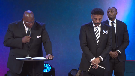 Chris Wheel (L), associate pastor of outreach at Elders of Oak Cliff Bible Fellowship Church in Dallas, Texas, announces the restoration of the church's founder, Tony Evans (2nd R), in a restoration ceremony on Oct. 5, 2025. Evans' son, Jonathan Evans (R), is expected to be formally confirmed as lead pastor of the church soon.