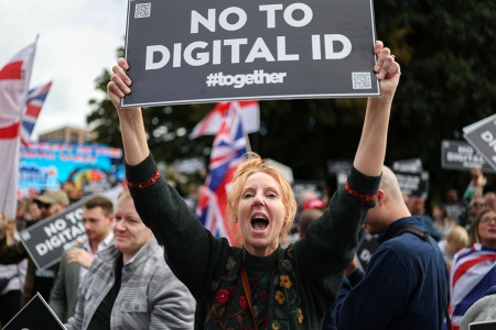 A demonstrator protests against the Labour government's plans to introduce a Digital ID, outside of the Labour Party's conference in Liverpool on Sept. 28, 2025, in Liverpool, England. Labour Conference is being held against a vastly different backdrop to last year when the party had swept to power in a landslide general election victory. A year on and polling shows three quarters of Britons (74-77%) say they have little to no trust in the party on the cost of living, immigration, taxation, managing the economy, representing people like them, or keeping its promises