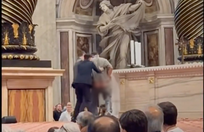 A man is apprehended for urinating at St. Peter's Basilica in the Vatican on Oct. 10, 2025.