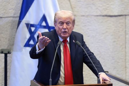 U.S. President Donald Trump addresses the Knesset, Israel's parliament, on October 13, 2025, in Jerusalem. President Trump is visiting the country hours after Hamas released the remaining Israeli hostages captured on Oct. 7, 2023, part of a US-brokered ceasefire deal to end the war in Gaza. 