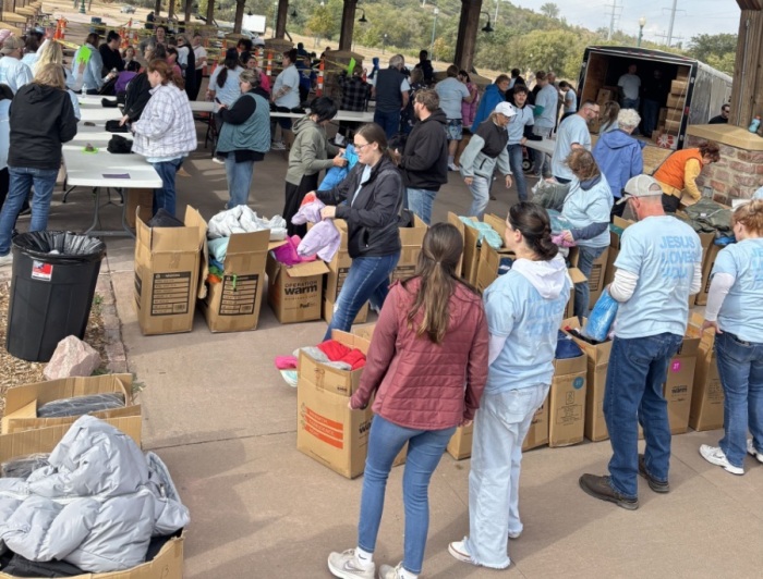 Volunteers receive 1,500 coats for children as part of the 2025 Kids-n-Coats charity drive at Harvest Church of Sioux Falls, South Dakota.
