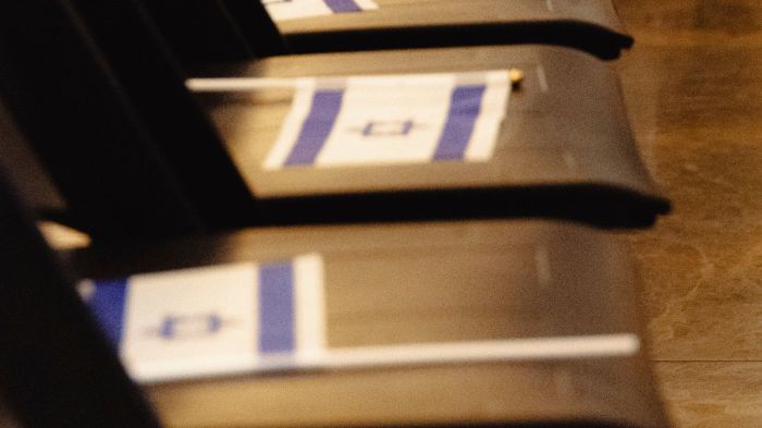 Israeli flags on top of chairs set up for an event at the Catholic University of America in Washington, D.C., on Oct. 20, 2025, featuring IDF soldiers Ron Feingold and Chanoch Berman.