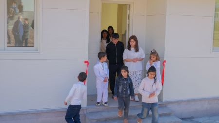 An Artsakh family from Martakert tours their new home during a handover ceremony in Svarants, Armenia, on Nov. 18, 2025. The house is one of 10 completed in a new model resettlement village assisting those who fled Azerbaijan's 2023 military takeover of Nagorno-Karabakh.