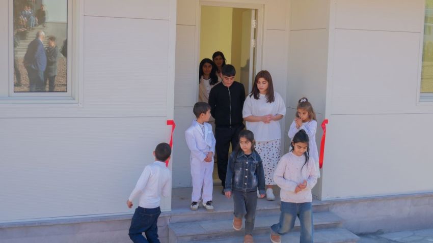 An Artsakh family from Martakert tours their new home during a handover ceremony in Svarants, Armenia, on Nov. 18, 2025. The house is one of 10 completed in a new model resettlement village assisting those who fled Azerbaijan's 2023 military takeover of Nagorno-Karabakh.