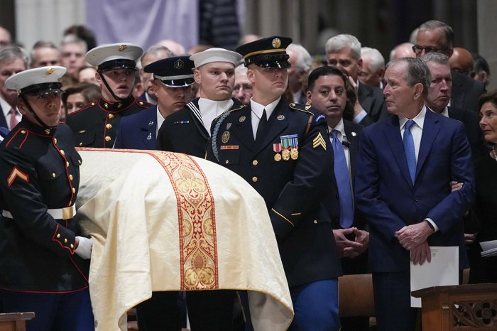 U.S. military body bearers carry the casket containing the remains of former U.S. Vice President Dick Cheney as former President George W. Bush stands at his funeral service at the National Cathedral on Nov. 20, 2025, in Washington, D.C. Cheney, who served as the 46th Vice President under President George W. Bush and as the 17th Secretary of Defense, died at the age of 84 due to complications from pneumonia and vascular disease.