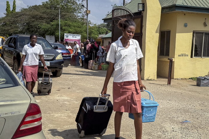 A student pulls her suitcase as she walks out of the Federal Government Girls College in Bwari, on the outskirts of Abuja, on Nov. 22, 2025. The national education ministry has ordered 47 boarding secondary schools across the country be shut after gunmen have kidnapped more than 300 students and teachers in one of the largest mass kidnappings in Nigeria, a Christian group said on Nov. 22, as security fears mounted in Africa's most populous nation. The early Nov. 21 raid on St Mary's co-education school in Niger state in western Nigeria came after gunmen on Nov. 17 stormed a secondary school in neighboring Kebbi state, abducting 25 girls.
