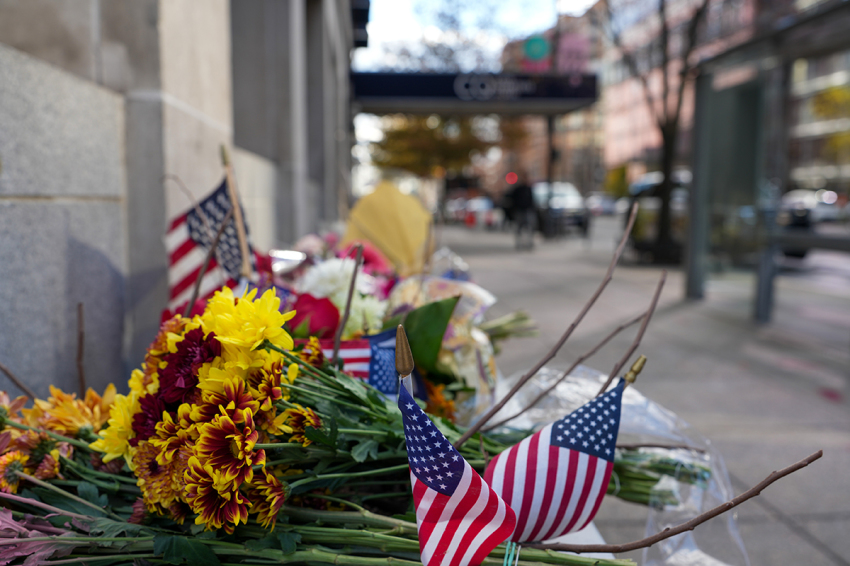 A makeshift memorial of flowers and American flags stands outside the Farragut West Metro station on Nov. 28, 2025, in Washington, D.C. One of the two West Virginia National Guard troops who were shot blocks from the White House on Nov. 26 died yesterday following what authorities called a targeted attack.