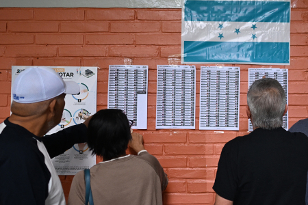 People check where to vote at a polling station during Honduras' general election in Tegucigalpa on Nov. 30, 2025. Hondurans voted for president on Nov. 30, 2025, amid threats by U.S. President Donald Trump to cut aid to the country if his preferred candidate loses.