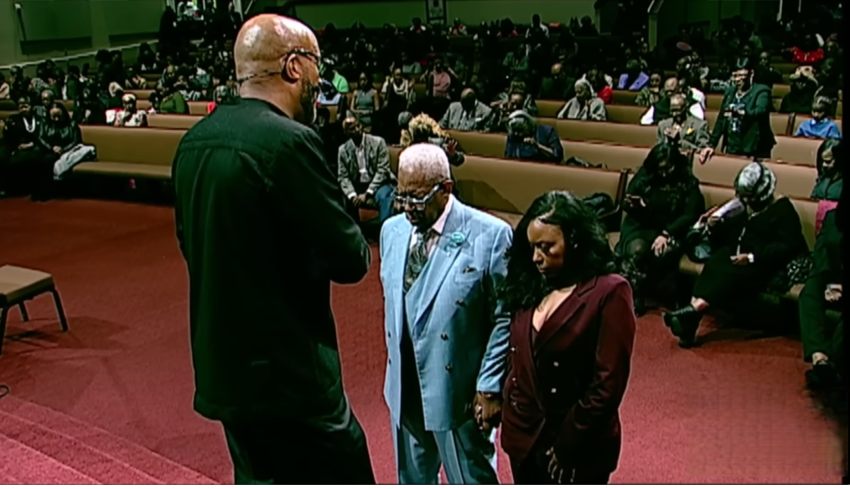 Rev. Frederick Douglass Haynes III prays over Rep. Jasmine Crockett, D-Texas, and her father, at Friendship-West Baptist Church in Dallas, Texas, on Sunday, December 7, 2025.