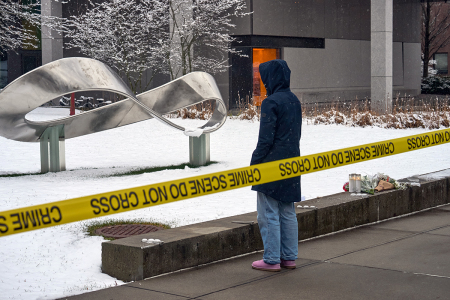 A person mourns at a makeshift memorial outside the Barus & Holley engineering building on the campus of Brown University, in Providence, Rhode Island, on Dec. 14, 2025. U.S. authorities on Sunday detained a person of interest in the mass shooting at Brown University that left two people dead and nine others wounded.