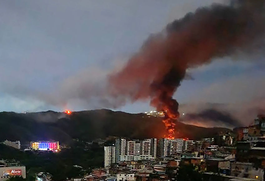 Fire at Fuerte Tiuna, Venezuela's largest military complex, is seen from a distance after a series of explosions in Caracas on January 3, 2026. The United States military was behind a series of strikes against the Venezuelan capital Caracas on Saturday, US media reported. The White House and Pentagon have not commented on the explosions and reports of aircraft over the city. US media outlets CBS News and Fox News reported unnamed Trump administration officials confirming that US forces were involved. 
