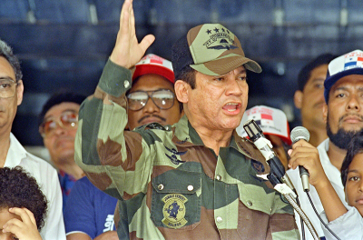 General Manuel Antonio Noriega speaks 20 May 1988 in Panama City during the presentation of colors to the San Miguel Arcangel de San Miguelito volunteer battalion. Noriega said that discussions with the U.S. could not continue as long as the U.S. continued its aggression and that Panamanian democracy will not follow a North American schedule.