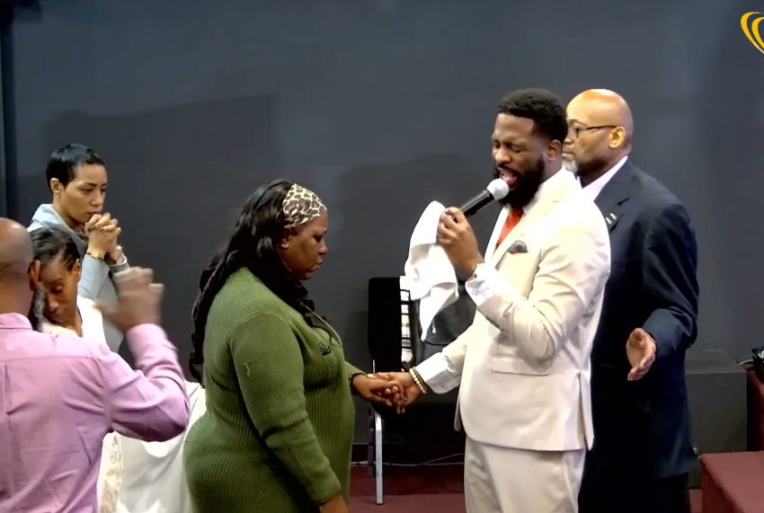 Ricky Lee Taylor, senior pastor of Arena of Praise in Chattanooga, Tenn. prays for one of his parishioners.