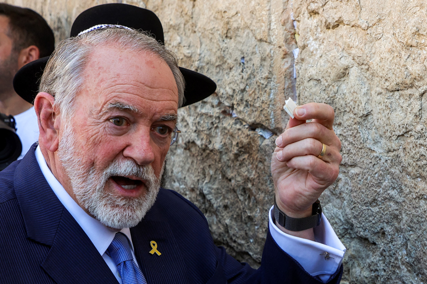 The U.S. Ambassador to Israel Mike Huckabee holds a note given to him from President Donald Trump to be placed in the cracks of the Western Wall, the holiest site where Jews are allowed to pray, during Huckabee's visit to the holy site in the old city of Jerusalem on April 18, 2025.
