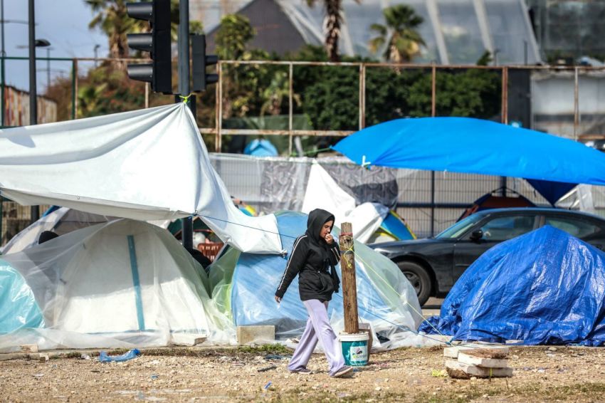 A displaced girl walks past tents covered in plastic sheeting to shield them from the stormy weather along Beirut's seafront area on March 15, 2026. Israel issued evacuation orders covering hundreds of square kilometres of Lebanon, displacing hundreds of thousands of people and prompting warnings of a humanitarian disaster. Lebanon was dragged into the Middle East war last week when Hezbollah attacked Israel in response to the killing of Iranian supreme leader in US-Israeli strikes, and the Tehran-backed group's leader has said the militants were ready for a long confrontation with Israel.