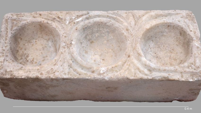 The rectangular marble block with three hemispheric cavities for oils.