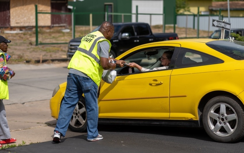 Volunteers with University United Methodist Church of Wichita, Kansas, handing out gas cards to commuters as part of their "Love at the Pump" event on April 25, 2026.