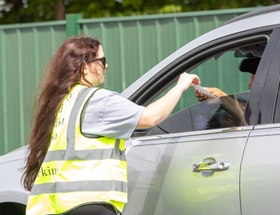 Volunteers with University United Methodist Church of Wichita, Kansas, handing out gas cards to commuters as part of their "Love at the Pump" event on April 25, 2026.