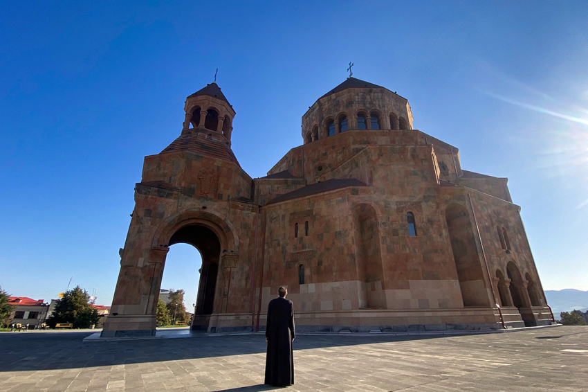 A priest stands in front of a church in Stepanakert on September 27, 2023. Armenia said on Sept. 27, 2023, that 42,500 refugees have arrived from Nagorno-Karabakh since Azerbaijan's lightning offensive, representing a third of the separatist ethnic Armenian enclave's population.