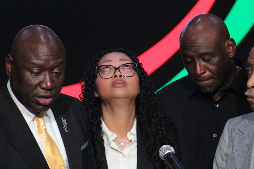 The late Nolan Wells’ mother, Christine Wonsley, tries to hold back tears as she talks about her son at a press conference in New York City on July 10, 2026. With her are renowned civil rights attorney Ben Crump (L), her husband, Elmore Wonsley, and civil rights leader the Rev. Al Sharpton (R).